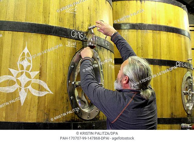 Winemaker Adi Badenhorst fetches a glass of Grenache from this year's harvest at his vinyard between Wellington and Paarl, South Africa, 20 July 2017
