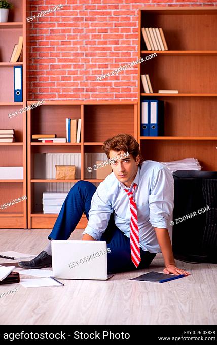 Unhappy businessman sitting in the office