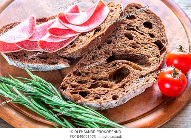Sandwiches with dark-rye bread and salami