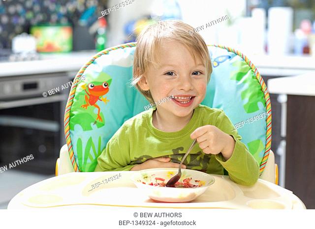 Four year old boy eating vegetable soup