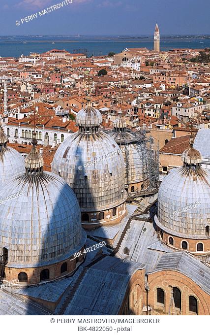 St Mark's Basilica with Romanesque domes and ornate Gothic and Byzantine architectural details plus old Renaissance architectural style residential buildings...