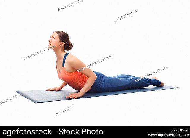 Beautiful sporty fit yogini woman practices yoga asana bhujangasana, cobra pose beginner variation isolated on white background