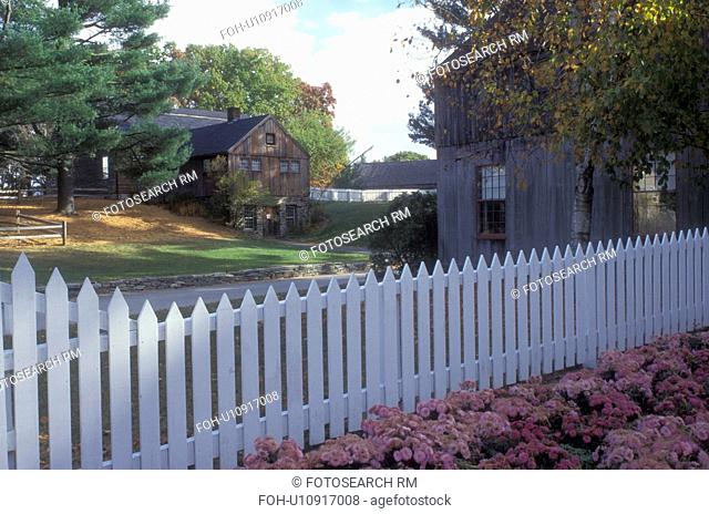 Sturbridge, Massachusetts, A white picket fence stands in front of historic buildings in the Old Sturbridge Village