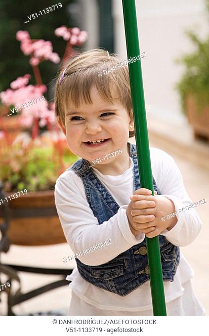 Playful young smiling girl in patio