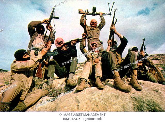 In the mountains east of the Jordan River, a patrol from the Popular Front for the Liberation of Palestine punctuates a battle hymn by discharging Soviet