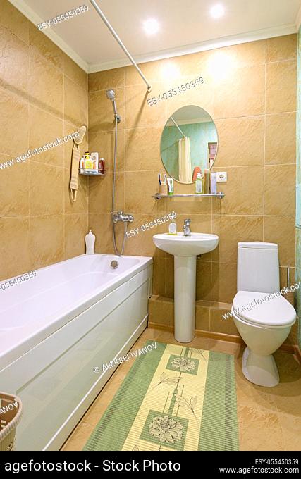 Interior of an ordinary standard classic bathroom joint with a toilet