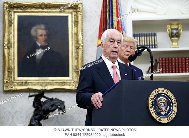 American racing magnate Roger Penske (L), with US President Donald J. Trump (R), delivers remarks during his Presidential Medal of Freedom ceremony in the Oval...