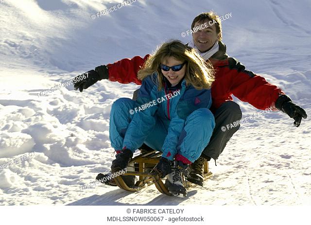 Woman and man doing sledge