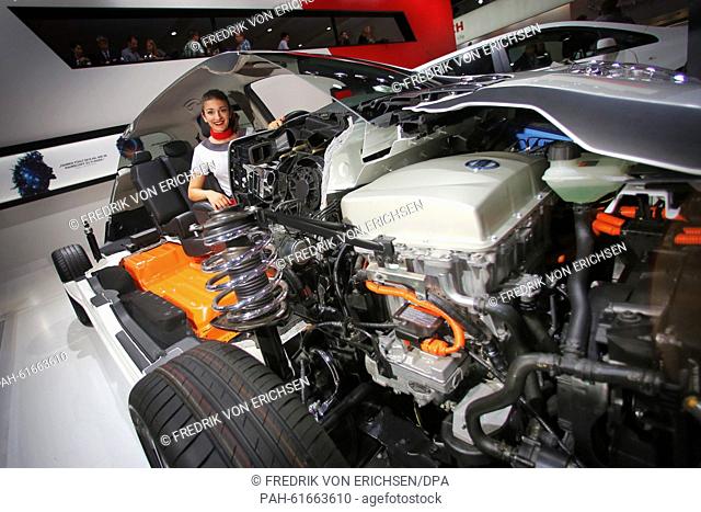 A hostess poses in a cutaway model of the Nissan Leaf electric car at the exhibition stand of Nissan at the International Motor Show IAA in Frankfurt/Main