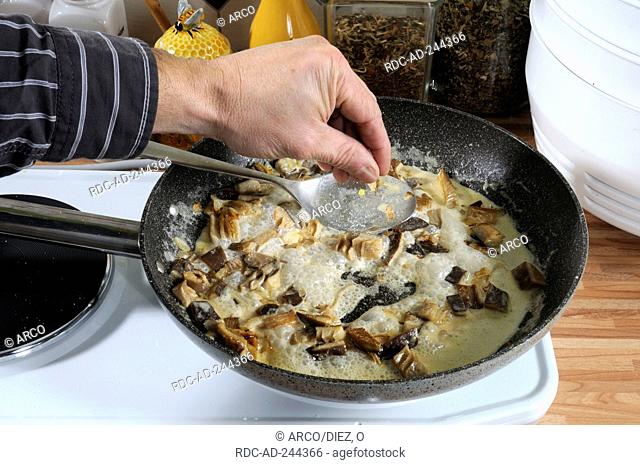 Frying Oyster Mushrooms in pan with butter Pleurotus ostreatus stove