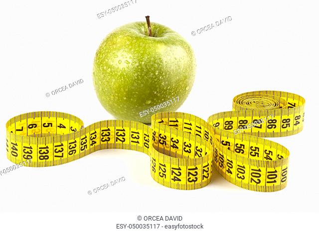 wet apple close-up with drops and yellow measure tape isolated on white