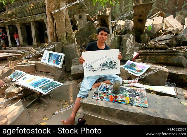 A boy sketches the architectura of angkor temple, Ta Prohm, Angkor, Cambodia