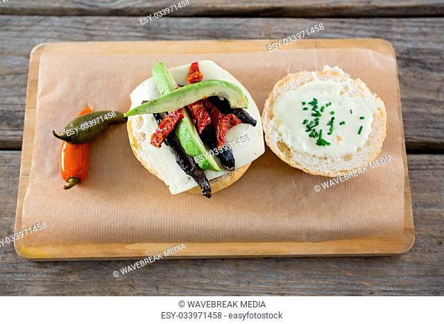 High angle view of vegetables with cheese and bun