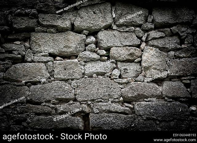 Old stone bricks wall texture background. Vintage dark toned