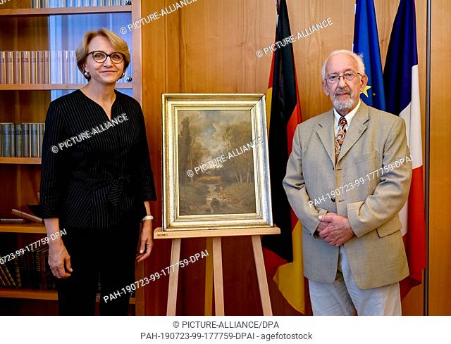 23 July 2019, Berlin: Anne-Marie Descôtes, France's ambassador to Germany, and Peter Forner stand next to the painting by the French painter Nicolas Rousseau