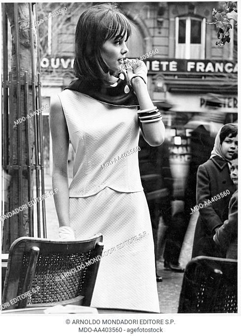 A model wearing a white piquet dress. A model wearing a two-pieces dress made of white smocking piquet by French fashion collection. 1960s