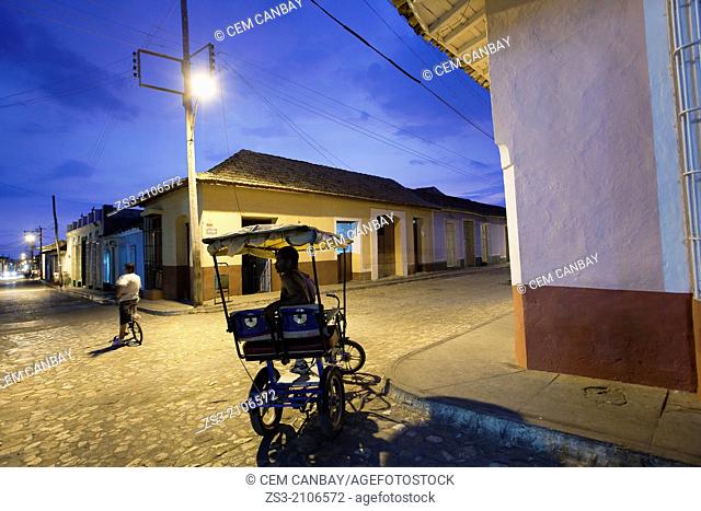 Bici Taxis on the cobblestone street by night, Trinidad, Sanct’ Sp’ritu Province, Cuba, West Indies, Central America