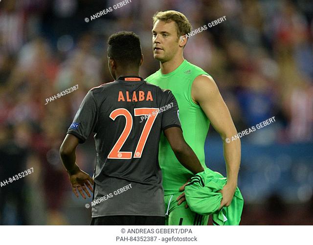 Munich's David Alaba (l) and goalkeeper Manuel Neuer reacting after the Champions League Group D soccer match between Atletico Madrid and Bayern Munich at the...