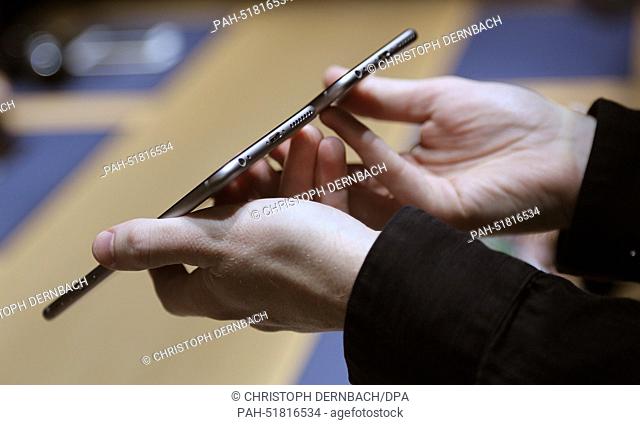 A hand holds two versions of Apple's new iPhone 6 during the product presentation of computer and software manbufacturer Apple in Cupertino, USA