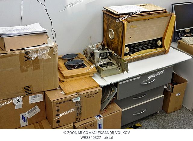 VILNIUS, LITHUANIA - DECEMBER 16, 2015: Vintage retro tube radio receiver repair in modern small service center. An antique radio is a radio receiving set that...