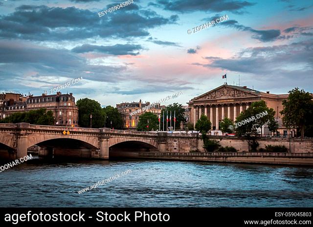 Blue and pink sunset over the National Assembly and the Seine River in Paris