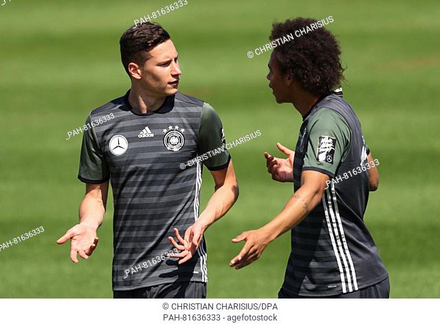 Germany's Julian Draxler (L) and Leroy Sane during a training session of the German national soccer team on the training pitch next to team hotel in Evian