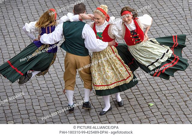 dpatop - 10 March 2018, Germany, Eisenach: Dancers perform a traditional choreography at the 'Eisenacher Sommergewinn' parade