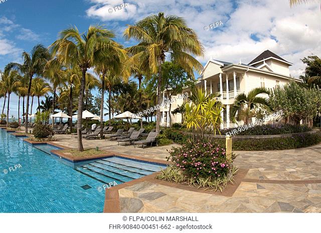 Swimming pool with palm trees and hotel building, Le Telfair Hotel, Bel Ombre, Southwest Mauritius