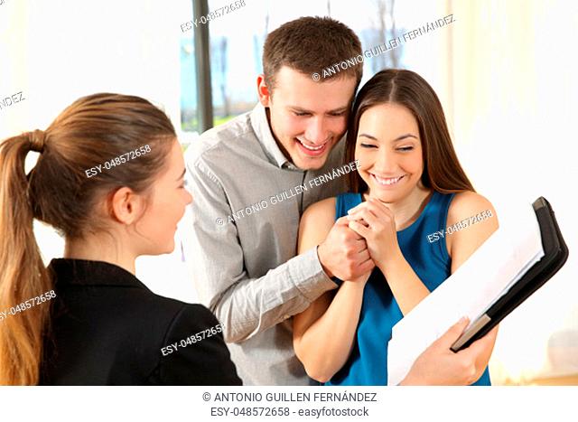 Real estate agent showing a new house plan to a nervous couple
