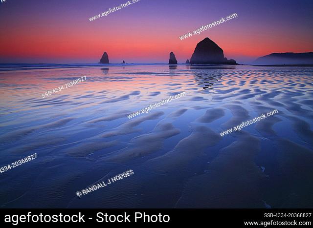 Sunset Afterglow and Sand Designs With Haystack Rock and The Needles From Cannon Beach in Oregon