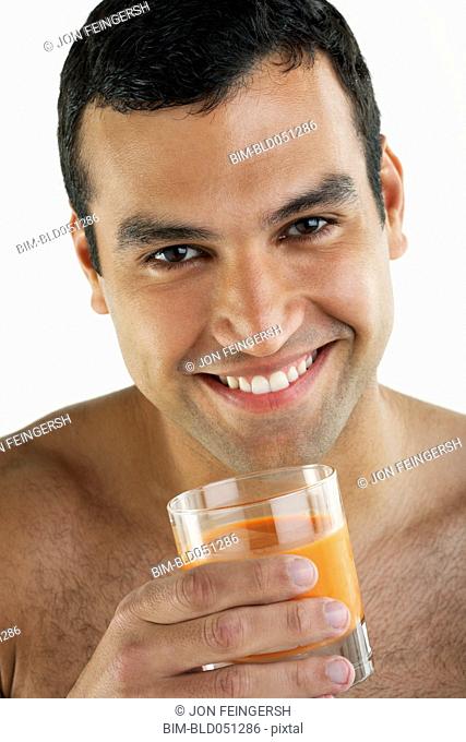 Hispanic man drinking juice