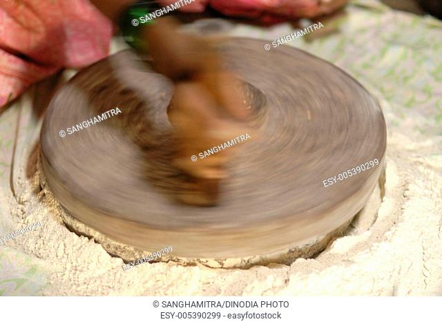 Traditional method of grinding flour ; hand mill ; Konkan ; Maharashtra ; India
