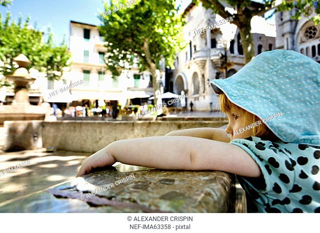 A little girl by a stone wall, Mallorca