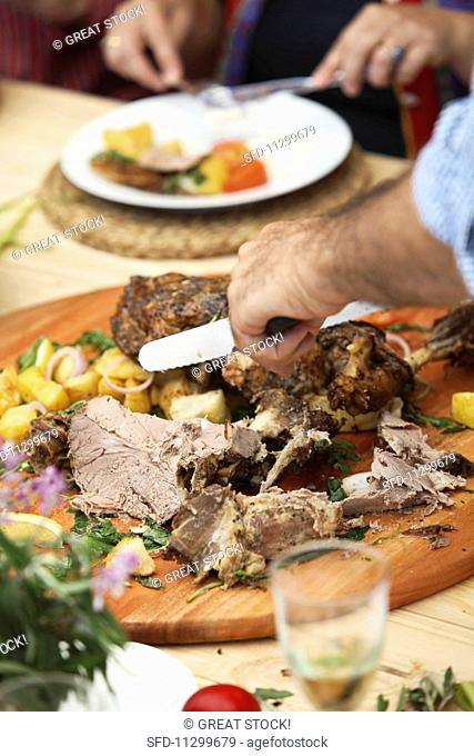Roasted leg of lamb being carved