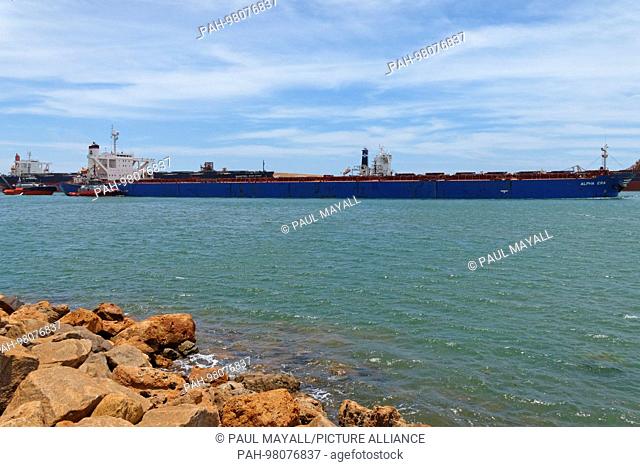 Iron Ore carrier Alpha Era, leaving harbour under tug boat escort, Port Hedland, Western Australia | usage worldwide. - /Western Australia/Australia