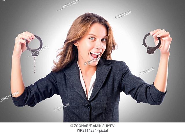 Female businesswoman with handcuffs on white