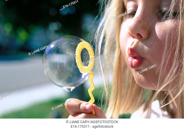 Girl blowing bubble