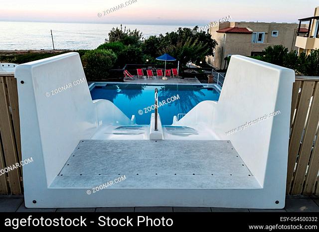 Double white water slide seen from the top of the pool in Crete
