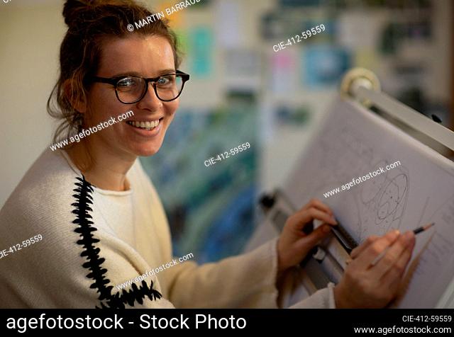 Portrait female architect working at drafting table