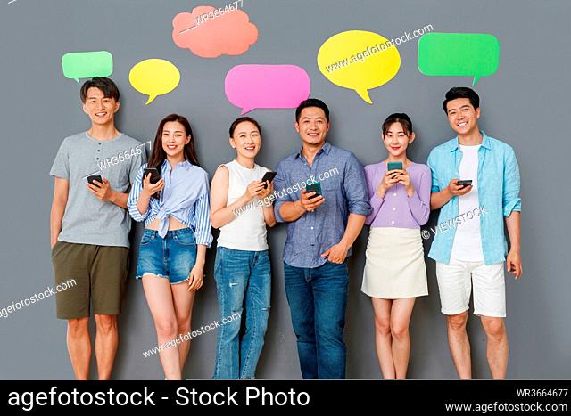 In the happy young people use mobile phone chat software to communicate