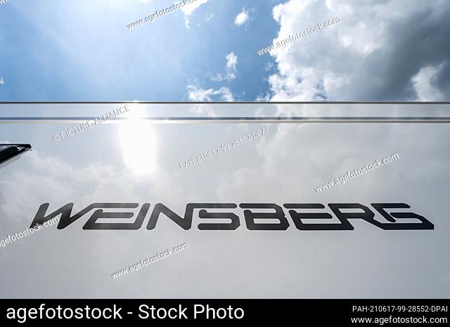 16 June 2021, Bavaria, Jandelsbrunn: The lettering of the Weinsberg des brand is attached to a motorhome at the Knaus-Tabbert AG factory