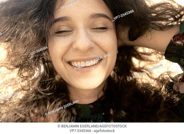 young happy unvarnished woman in sunlight