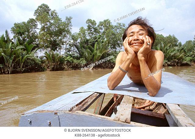 Smiling fisherman on Mekong River, near Saigon. Vietnam