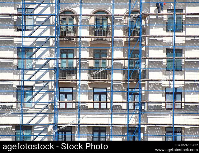 The facade of a residential building in scaffolding. Photography in Moscow