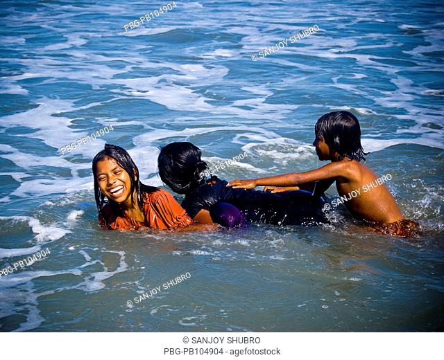 Girls taking bath at the Saint Martin's Island, locally known as Narkel Jinjira, is the only coral island and one of the most famous tourist spots of Bangladesh...