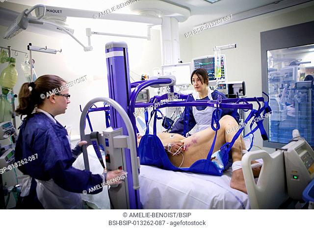 Reportage in Robert Ballanger hospital's Intensive Care Unit in France. A nurse and nursing auxiliary weighing a patient