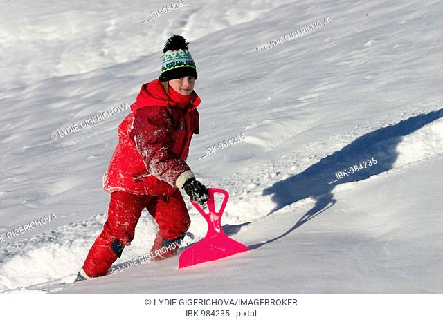 Girl 9 years old with snow-slider, Dolomites, Italy, Europe