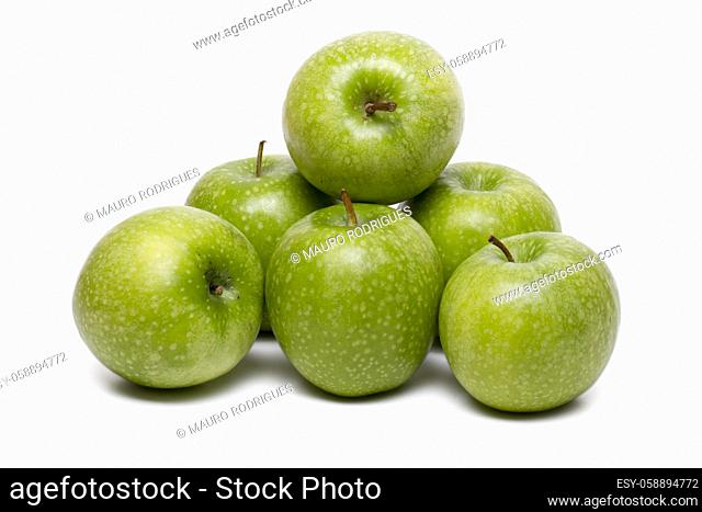 Close up view of a single green apple isolated on a white background