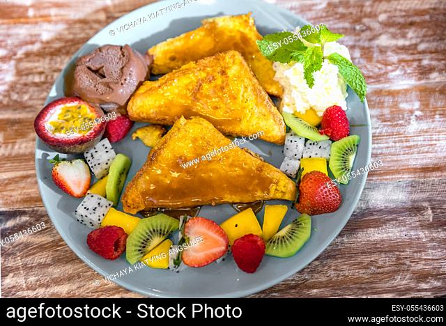 French toast served with exotic tropical fruit with ice cream gelato
