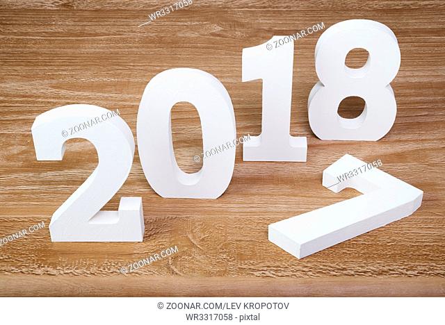 White digits 2018 and digit 7 on rustic wooden background as concept of New Year and Christmas